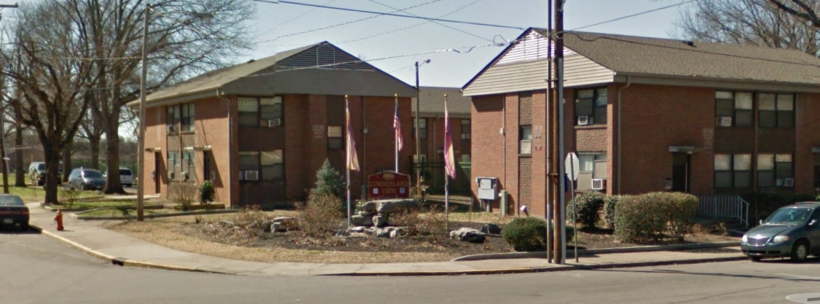a row of brick apartment buildings on the corner of a street